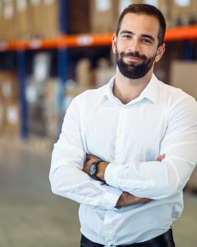 Logistics manager posing in warehouse