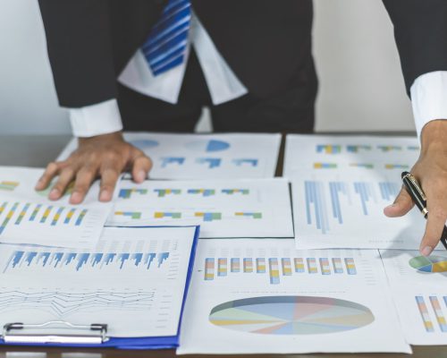 Young Asian businessman financial market analyst sits at their desks and calculate financial